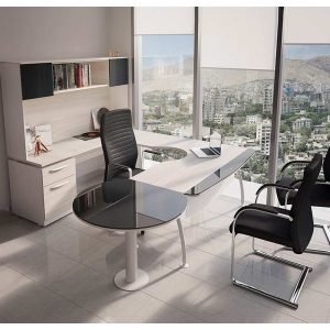 Escritorio ejecutivo de madera oscura con una silla ergonómica y un ordenador portátil en la superficie.